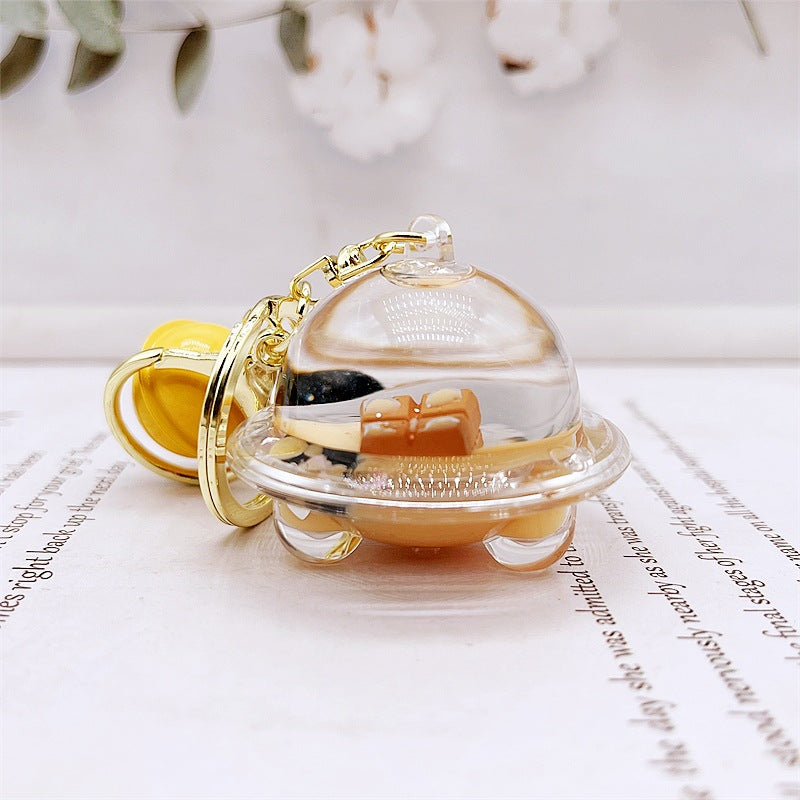 Comercio al por mayor acrílico flotando en el aceite de chocolate arenas movedizas llavero creativo